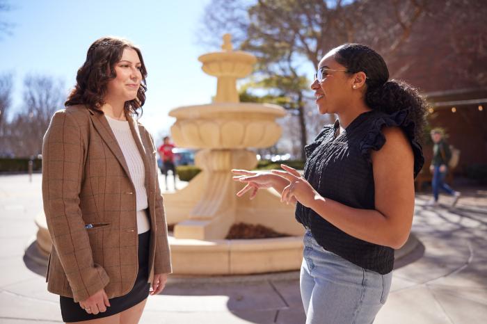 Students talk by fountain